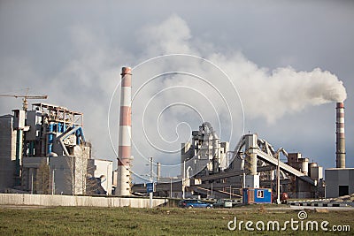 Cement plant smoke from the pipe manufacturing factory Stock Photo