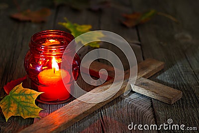 Cemetery red lantern candle with autumn leaves in night Stock Photo