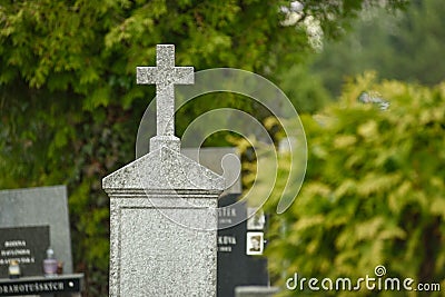 Cemetery with tombstones in the shape of a cross, angels. Many decorated graves Stock Photo