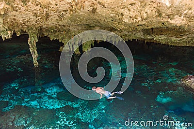 Cenote Dos Ojos in Quintana Roo, Mexico. People swimming and snorkeling in clear water. This cenote is located close to Tulum in Stock Photo