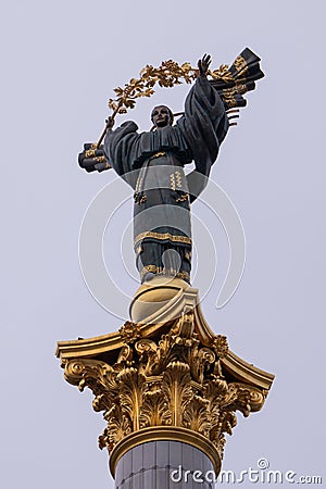 In the center of Kyiv, the Independence Monument stands against a cloudy gray sky. Editorial Stock Photo