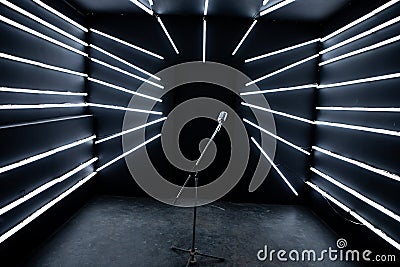 Center positioned microphone With Stand in Music Studio with Black walls and lights at background full View 3d Stock Photo