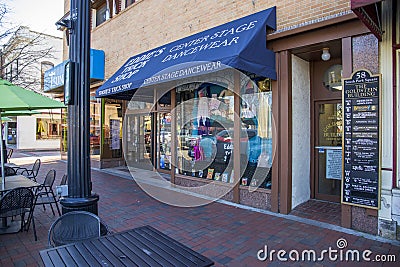 Center Stage Dancewear with clothing and apparel in the storefront window and a blue awning in the window in the Marietta Square Editorial Stock Photo