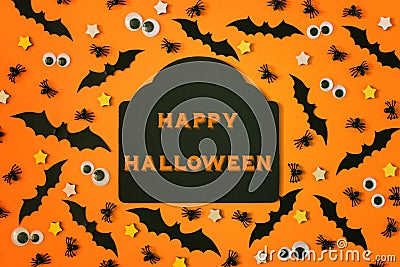 In the center there is tablet with an inscription. Happy Halloween. Many ornamental spiders, puppet eyes and bats are Stock Photo