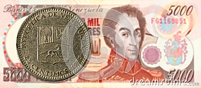 25 centimos coin against 5000 venezuelan bolivar bank note Stock Photo