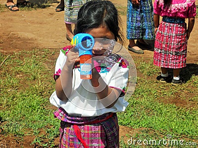 Central American Girl with a Bubble Machine Editorial Stock Photo