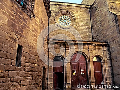 Central entrance to the medieval gothic Collegiate church of Santa Maria in Cervera Catalonia, Spain. Wooden arch-shaped doors Stock Photo