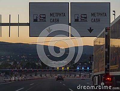 Central Greece. July 2019: Trip on the toll highway Athens-Thessaloniki, past cars, gas stations, toll checkpoints at sunset in th Editorial Stock Photo