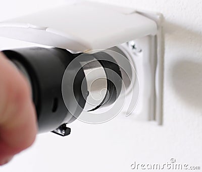 Plugging central vacuum cleaner in to wall inlet Stock Photo