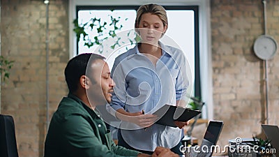 Ceo monitoring work colleagues sitting coworking space. Manager listening remark Stock Photo