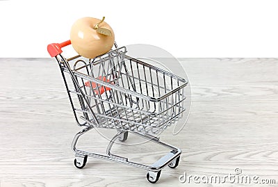 Ceramic Apple in a Miniature Shopping Cart Stock Photo