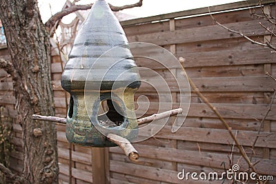 Ceramic birdhouse with birdseed Stock Photo