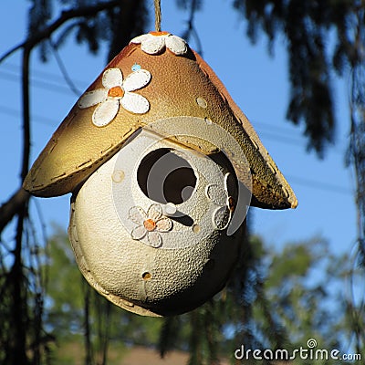Ceramic Birdhouse hanging in a tree. Stock Photo