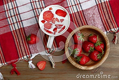 Ceramic Cup of Yogurt,Red Fresh Strawberries are in the Wooden Plate on the Check Tablecloth with Fringe.Breakfast Organic Healthy Stock Photo