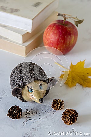 Ceramic handmade hedgehog in autumn theme on a table Stock Photo