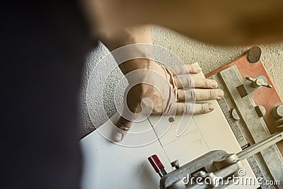 CERAMIC RIPPING. TILERS IN WORK. INSTALL AND CUT. PAVING INDOOR. Stock Photo