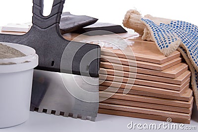 Ceramic tiles and trowel for repairs Stock Photo