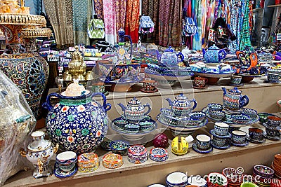 Ceramic Uzbek souvenir painted tea sets and handmade plates at the bazaar. Traditional national art. April 29, 2019 Editorial Stock Photo