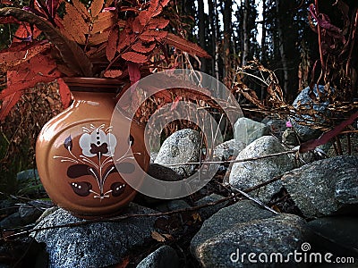 Ceramic vase in an autumn forest Stock Photo