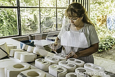Woman ceramist working in ceramic studio. Stock Photo
