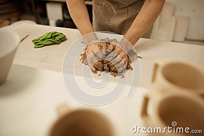 Ceramist working with a piece of clay on a studio table Stock Photo