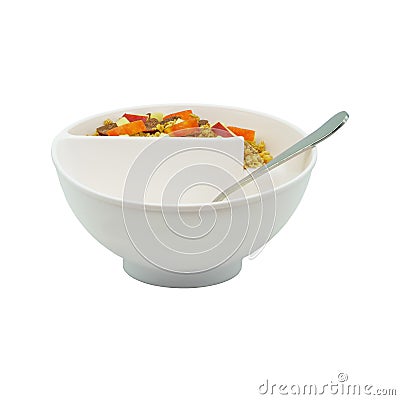 A cereal bowl with spoon, apples and cereals, white background, close-up Stock Photo