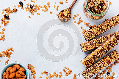 Cereal granola bar with nuts, fruits and berries on a whhite stone table. Granola bar. Healthy snack. Stock Photo