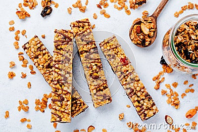 Cereal granola bar with nuts, fruits and berries on a whhite stone table. Granola bar. Healthy snack. Stock Photo