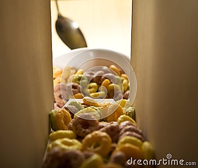 Cereal loops pouring out of the box Stock Photo