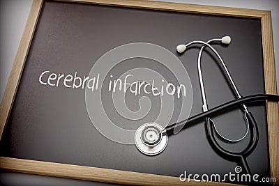 Cerebral infarction written in chalk on a blackboard black next to a stethoscope Stock Photo