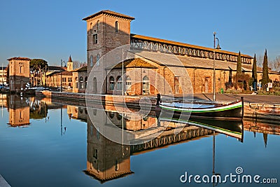 Cervia, Ravenna, Emilia-Romagna, Italy: the port canal with the ancient salt warehouse Stock Photo