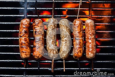 Cevapcici sausages sizzling on a hot grill Stock Photo