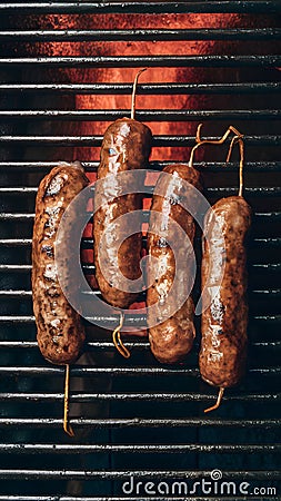 Cevapcici sausages sizzling on a hot grill Stock Photo