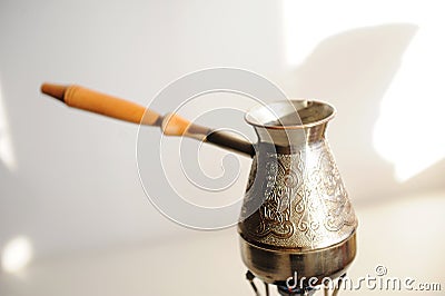 Cezve coffee brewing on gas-burner. White background Stock Photo