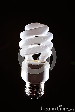 Cfl lightbulb light on black Stock Photo