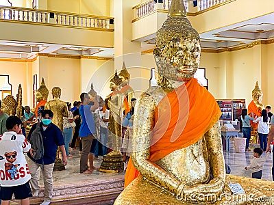 Many people pray respect Golden Buddha statue inside Editorial Stock Photo