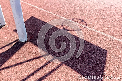 Chadow of basketball hoop at the red playground Stock Photo