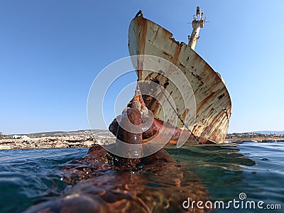 Chain emerging from the water facing the ship Stock Photo