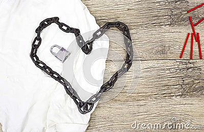 Chain heart shape with lock on white rag. Stock Photo