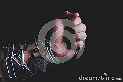 Chain and lock on hand. Arrest of a criminal. Handcuffs on the prisoner. Stock Photo