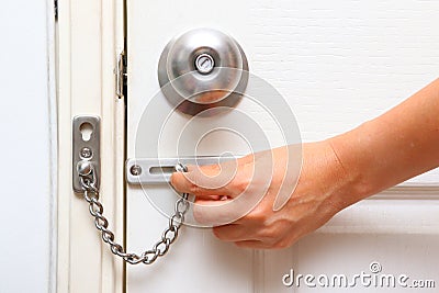 Chain lock and knob lock in door Stock Photo