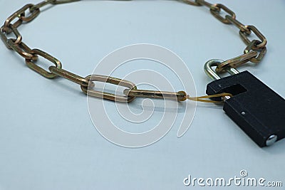 A chain and a lock. One of the rings is a rubber band. Stock Photo