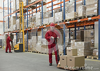 chain supply - two workers in storehouse Stock Photo