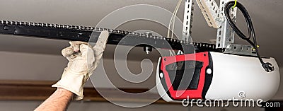 Testing the chain tension on a garage door opener Stock Photo