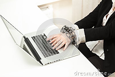 Chained businesswoman typing on keyboard Stock Photo