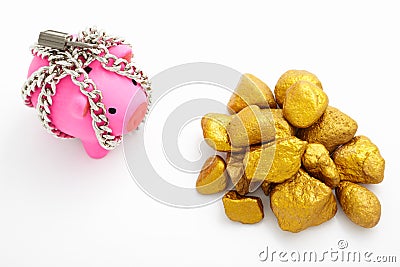 Chained piggy bank and gold Stock Photo