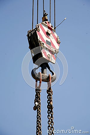 Chains with crane hook as industrial background Stock Photo