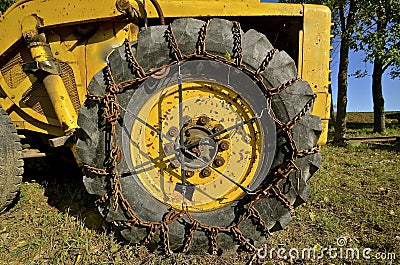 Chains on huge tire of an excavating machine Stock Photo