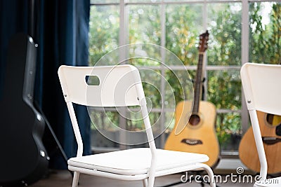 chair and acoustic guitar. Time for hobby and leasure Stock Photo