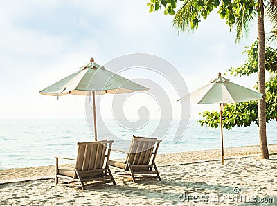 Chair Beach and Umbrella on Sand at Coast with blur Blue Sea and Cloud Sky Background Tropic Ocean Island Paradise with Sunny Stock Photo